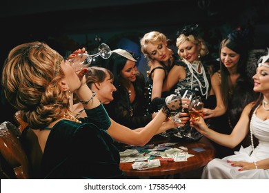 Beautiful women in evening dresses with champagne glasses - Shutterstock ID 175854404