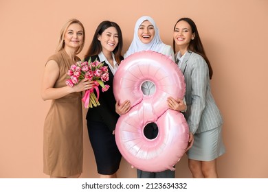 Beautiful women with flowers and balloon in shape of figure 8 on color background. International Women's Day celebration