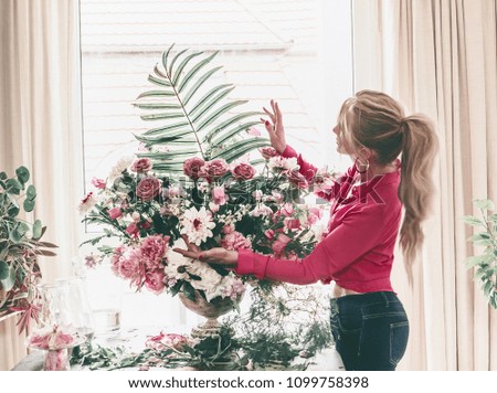 Woman arranges luxury bouquet of flowers