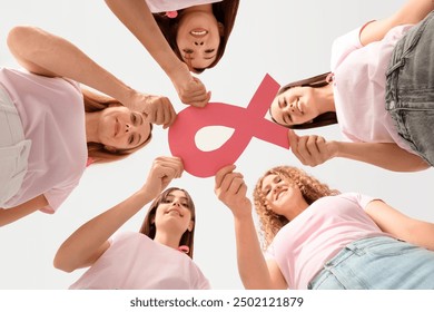 Beautiful women with pink ribbon on color background, bottom view. Breast cancer awareness concept - Powered by Shutterstock