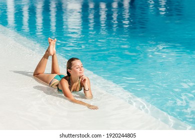 Beautiful women relaxing at the luxury poolside. Female at travel spa resort pool. Summer luxury vacation.