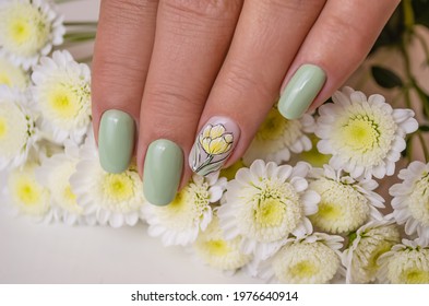 Beautiful Women's Hands With Spring Manicure Nails With Yellow Flower.