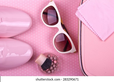 beautiful women's minimal set of fashion accessories on a pink background: shoes, sunglasses, powder and handbag. Place for text. Ideal for blogs or magazines. Mock up.