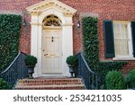 beautiful wood door in brick house with brick porch.