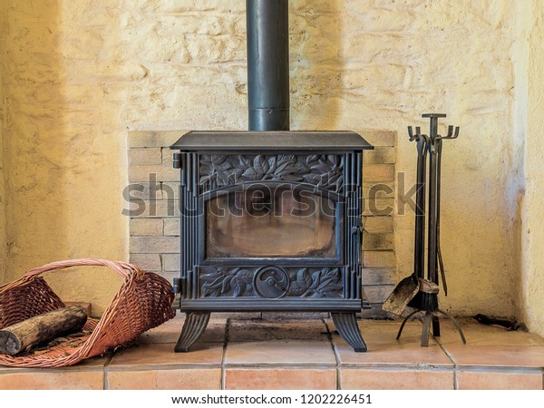 Beautiful wood stove with fireplace set tools in\
the stones house