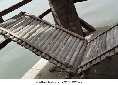 Beautiful Wooden Chair With Sun Over Riverbank