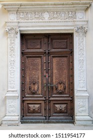 a beautiful wooden door at the entrance to an old castle. The door is carved with many details and shapes
