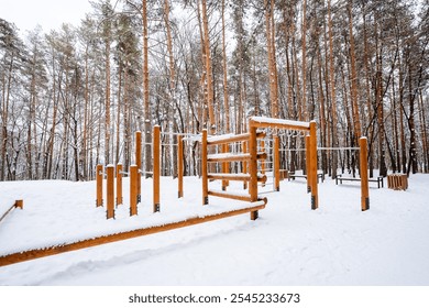 A beautiful wooden playground situated in the snow, surrounded by tall, majestic trees in the background, creating a picturesque winter landscape that evokes a sense of wonder and tranquility - Powered by Shutterstock