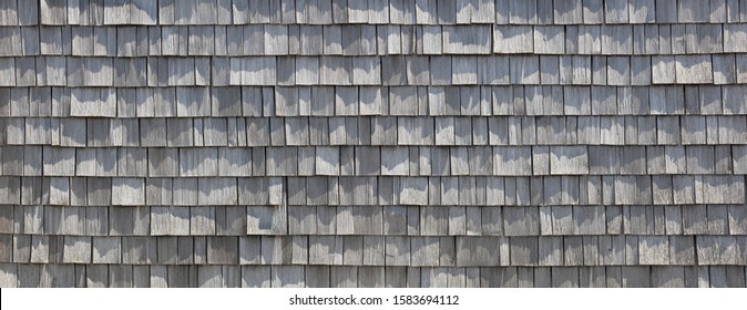 Beautiful wooden shingles on a house wall in the bavarian mountains.
