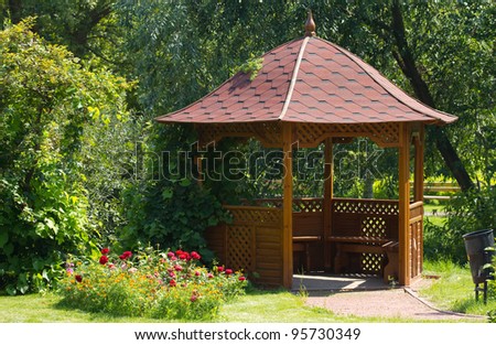 Beautiful wooden summerhouse and flowers