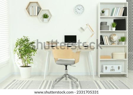Beautiful workplace with comfortable desk and chair at home