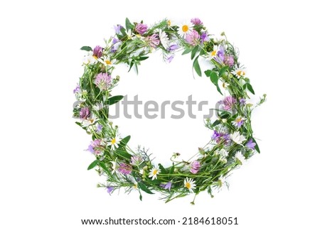 Beautiful wreath with colorful flowers isolated on a white background. Midsummer celebration concept, summer decoration. Top view.