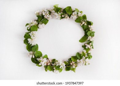 A Beautiful Wreath Of Green Spring Apple Branches With Pink And White Flowers And Buds On A White Background. 