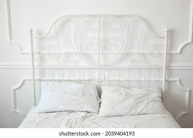 Beautiful Wrought Iron Bed In A White Bedroom 