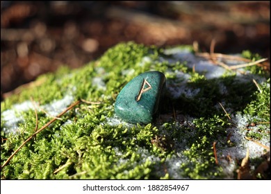 Beautiful Wunjo Rune made of Bloodstone with mossy background