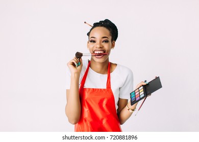 Beautiful Young African American Beautician Woman Holding Set Of Make Up Brushes.