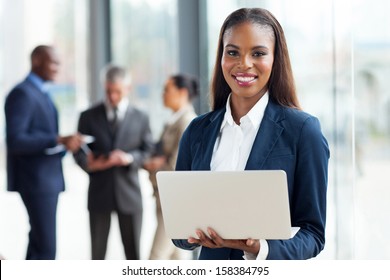 beautiful young african american businesswoman using laptop computer in office