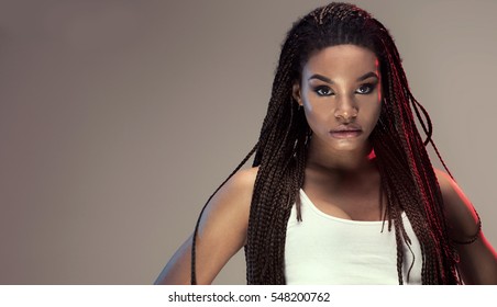 Beautiful young african american girl with long braids and glamour makeup.