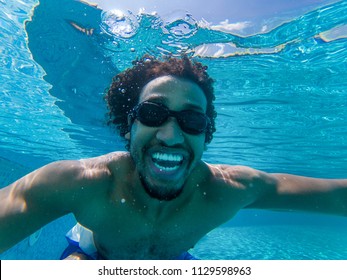 Beautiful Young African American Man Diving In A Swimming Pool Taking A Selfie