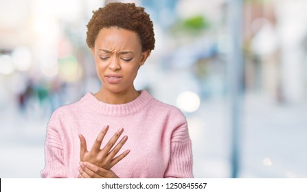 Beautiful young african american woman over isolated background Suffering pain on hands and fingers, arthritis inflammation