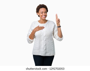 Beautiful Young African American Woman Wearing Sweater Over Isolated Background Swearing With Hand On Chest And Fingers, Making A Loyalty Promise Oath