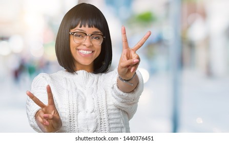 Beautiful young african american woman wearing glasses over isolated background smiling looking to the camera showing fingers doing victory sign. Number two. - Shutterstock ID 1440376451