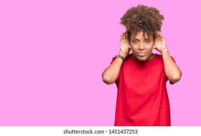 Beautiful young african american woman over isolated background Trying to hear both hands on ear gesture, curious for gossip. Hearing problem, deaf - Shutterstock ID 1451437253