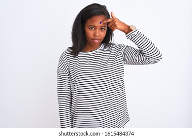 Beautiful young african american woman wearing winter sweater over isolated background pointing unhappy to pimple on forehead, ugly infection of blackhead. Acne and skin problem