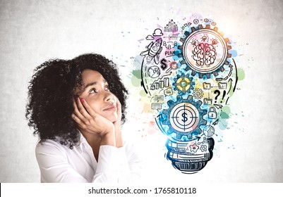 Beautiful Young African American Woman Dreaming And Thinking About Business Idea. Colorful Sketch Drawn On Concrete Wall. Concept Of Planning And Business Strategy