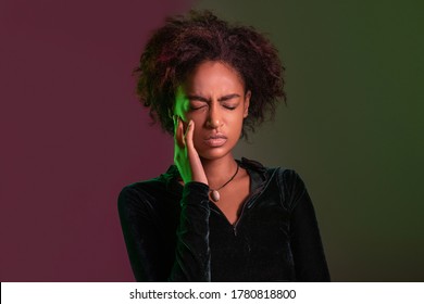 Beautiful Young African American Woman Over Isolated Background Touching Mouth With Hand With Painful Expression Because Of Toothache Or Dental Illness On Teeth. Dentist Concept