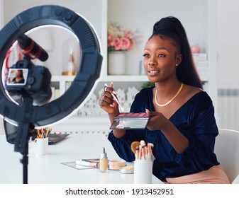 beautiful young african american woman streaming a beauty vlog from home, online content creator applying a makeup on - Shutterstock ID 1913452951