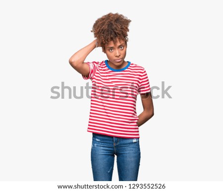 Beautiful young african american woman over isolated background confuse and wonder about question. Uncertain with doubt, thinking with hand on head. Pensive concept.