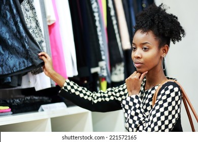 beautiful young african girl shopping in clothe's department