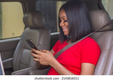 Beautiful Young African Lady Using Her Phone In A Car