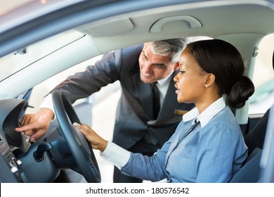 Beautiful Young African Woman Buying A Car At Dealership