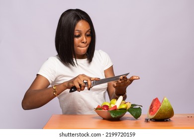 Beautiful Young African Woman Making Fruit Salad