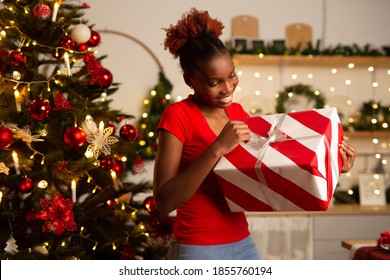 Beautiful Young African Woman Near Christmas Tree With New Year Gift