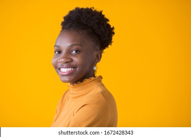 beautiful young african woman on yellow background