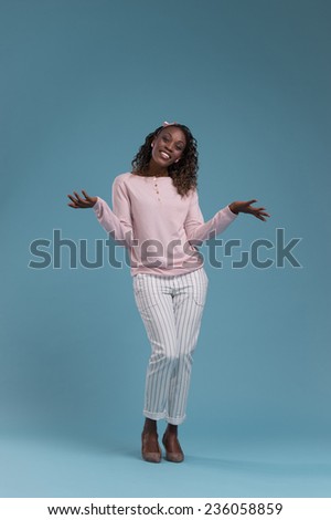 Beautiful young african woman on blue background