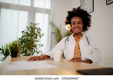 Beautiful Young Afro American Female Doctor Taking A Coffee Break, Resting, Smiling And Looking At The Camera.