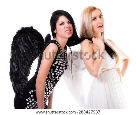 Beautiful young angel pulls black angel's hair isolated over white background