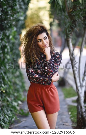 Beautiful young arabic woman with black curly hairstyle