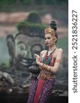 Beautiful young ASEAN woman in traditional Thai Dvaravati dress in an old temple in Chiang Mai, Thailand. 