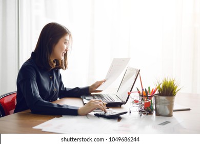 Beautiful young Asia woman working in office