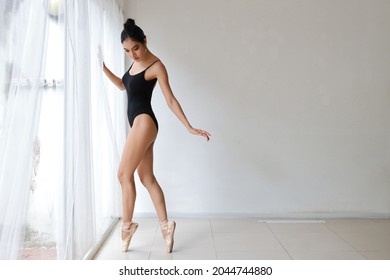 Beautiful Young Asian Ballet Dancer On White Wall Studio