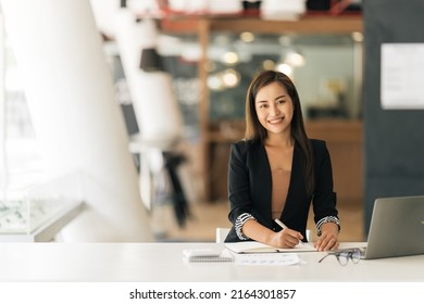 A Beautiful Young Asian Business Woman Using Laptop Computer While Working In Office