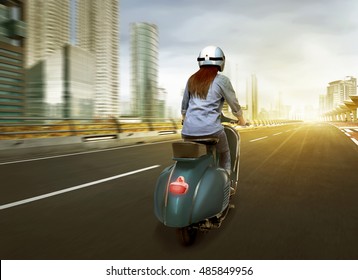 Beautiful Young Asian Enjoying Riding Scooter While Sunrise In The City