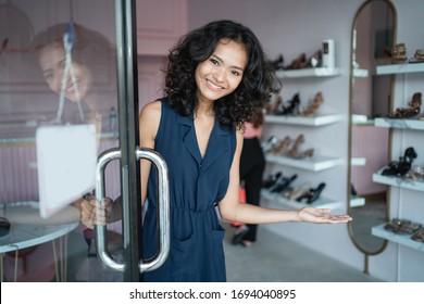 Beautiful Young Asian Fashion Shop Owner At Her Boutique Standing Proudly Welcoming Customer Open The Front Door