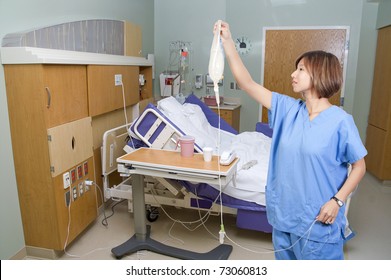 A Beautiful Young Asian Female Doctor Holding An IV Bag