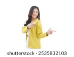  Beautiful young Asian girl with hand gesture pointing to the side isolated on white background. Cheerful excited asian woman use finger pointing to side with product or empty copy space